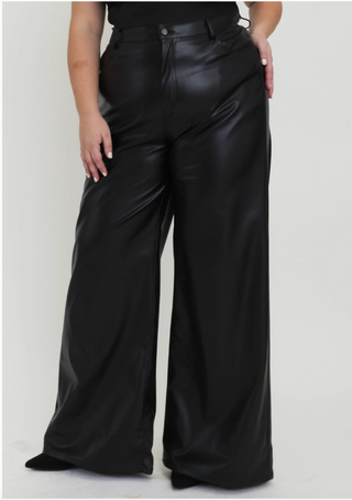 Plus sized woman wearing black coated pants. 