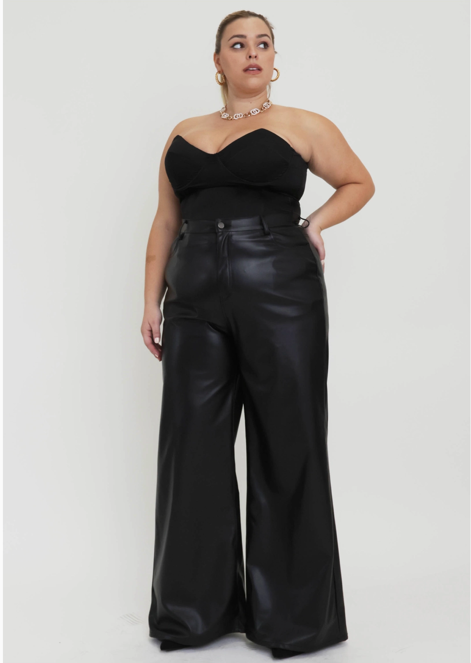 Plus sized woman wearing black coated pants. 