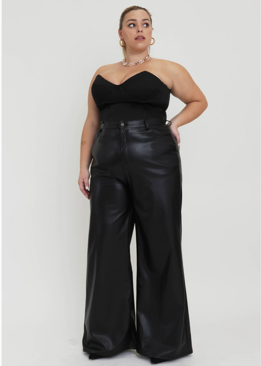 Plus sized woman wearing black coated pants. 