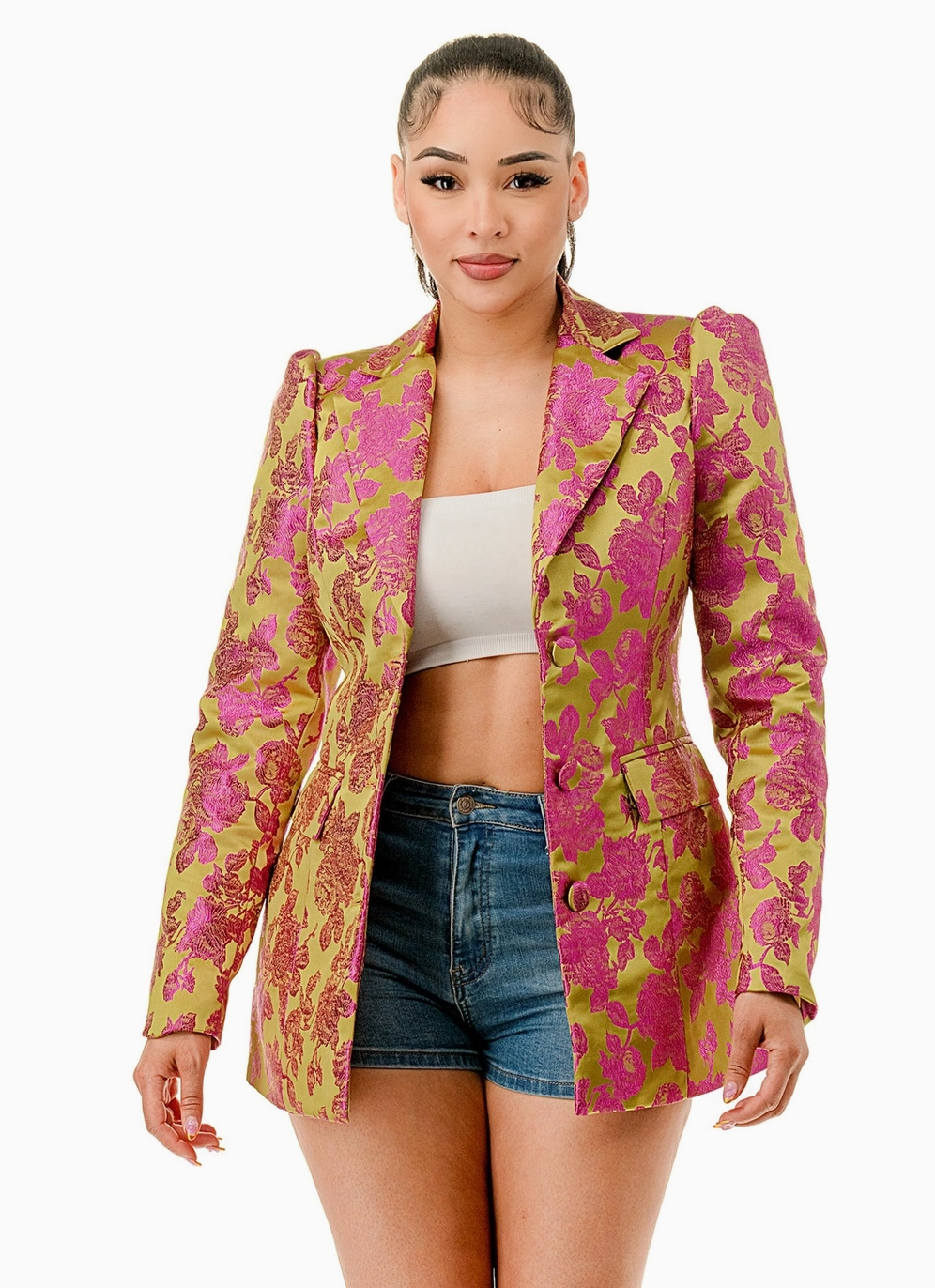 Woman wearing the Opulent Bloom Blazer, a luxurious floral brocade blazer in fuchsia and lime green. The blazer features a structured silhouette, notched lapel, and single-breasted button closure, creating a chic and sophisticated look.
