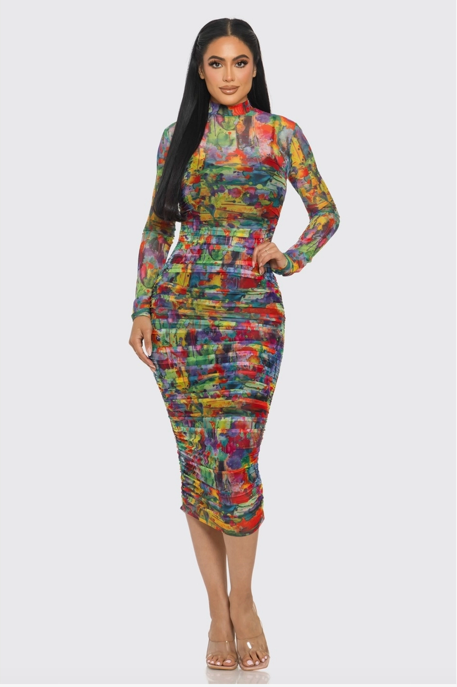 Woman wearing a midi length multicolor long sleeved dress. 