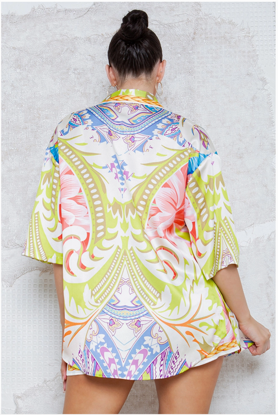 The back of the colorful button down top. 