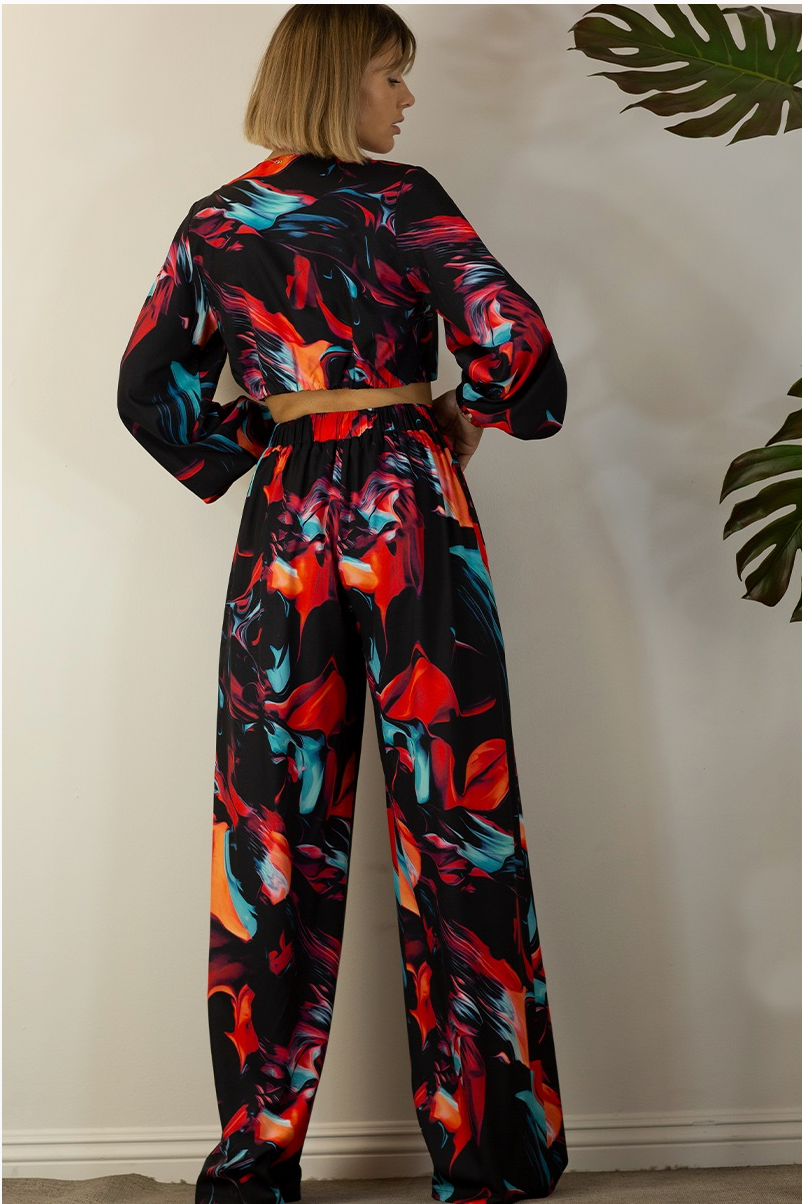 The back of a woman wearing a multicolored pants set with a wrap crop top and straight-leg pants. 