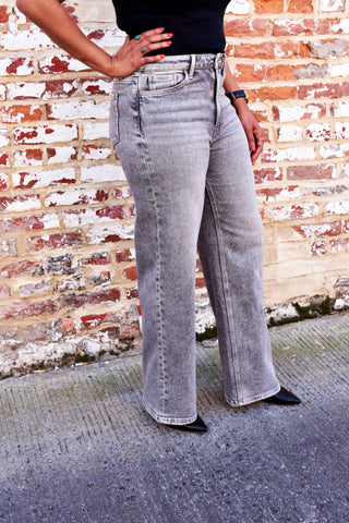 Woman wearing The Olivia - Grey Wide Leg Jeans, showing them from a side viewpoint.