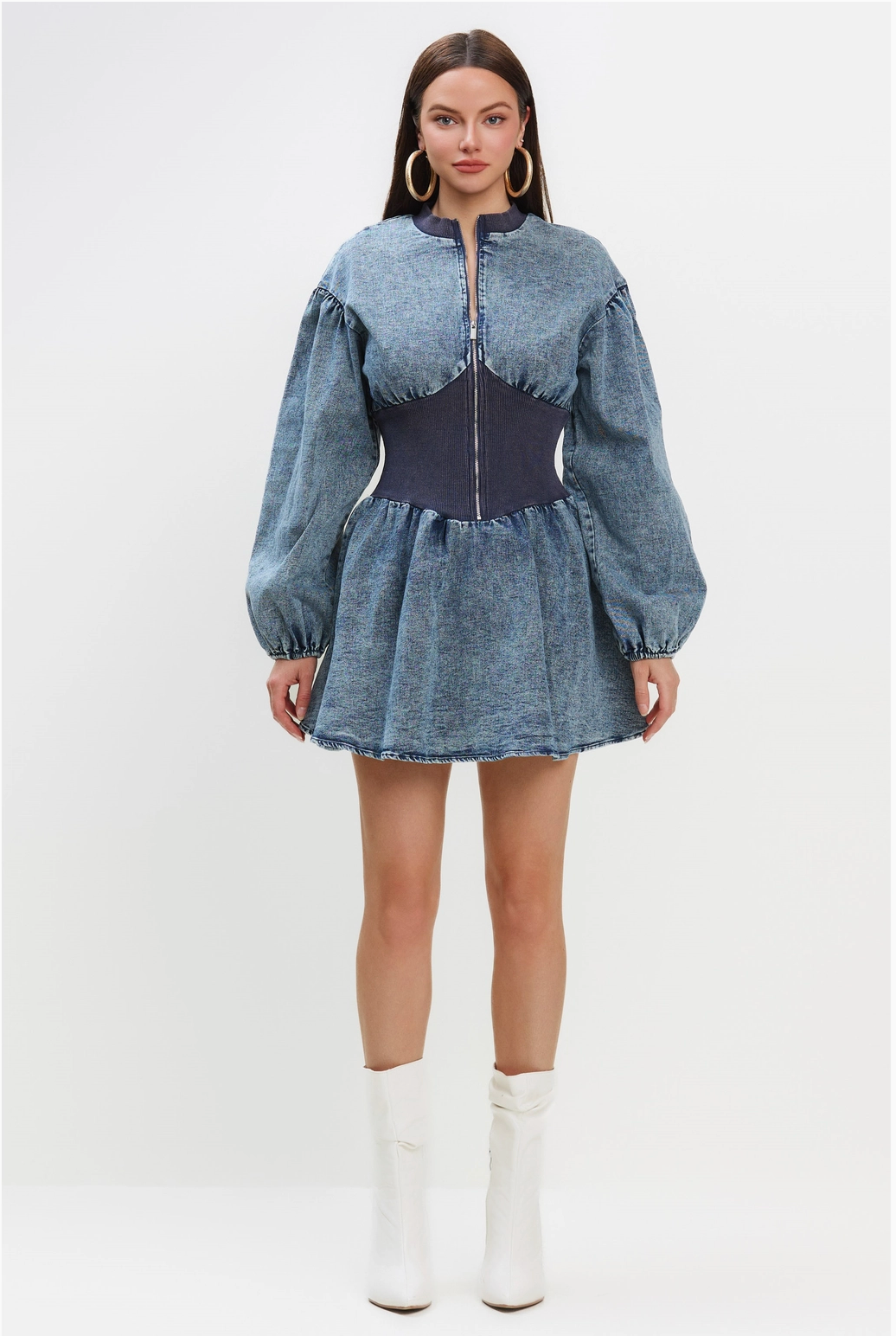 A woman wearing a Vintage style Jean Dress with a fitted waist, puff sleeves, and a zip-up front.